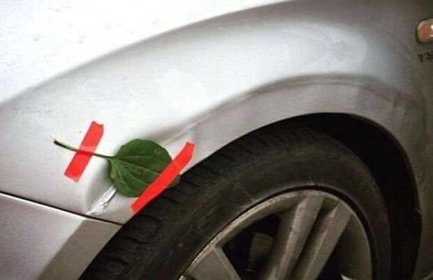 Redneck car repair of fixing a dent with a leaf