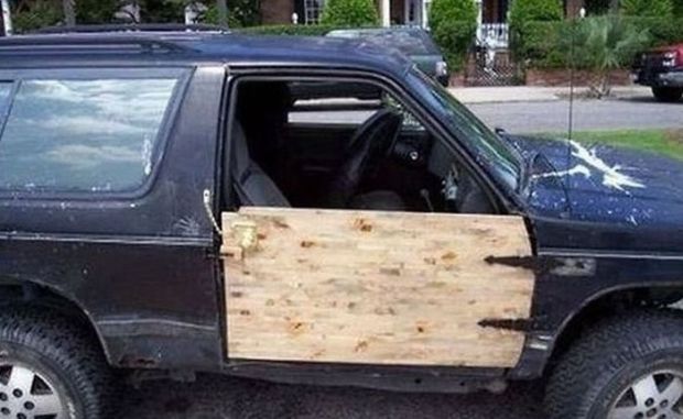 Redneck car repair of using wooden plank board for passenger side door