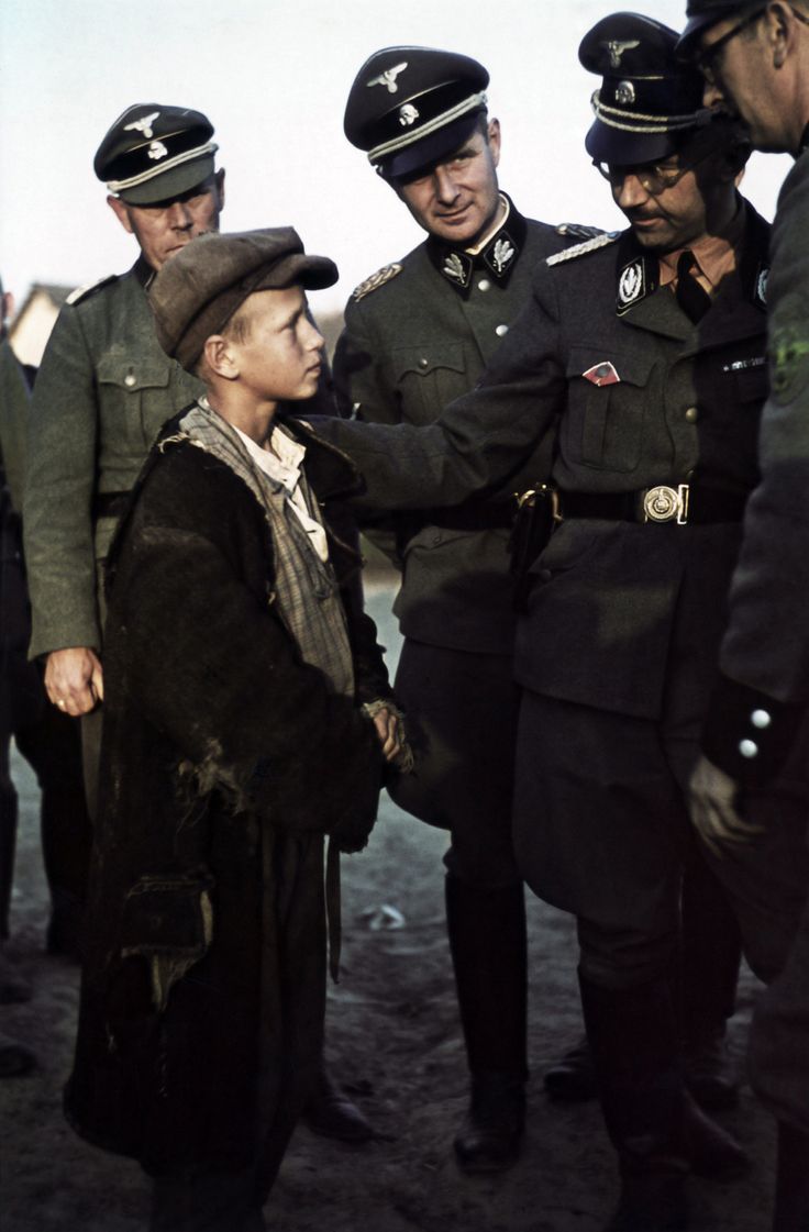 This colorized Nazi propaganda photo shows the Reichsfurer of the SS Heinrich Himmler with a Ukrainian boy in occupied Ukraine in 1942. This was part of the program called the Lebensborn Project. The Nazi would confiscate any qualified Aryan child from occupied territories, transport them to Germany, and have them adopted and raised by a true German family. Thousands of children were stolen this way all across the Reich, but mostly it occurred on the Eastern front.