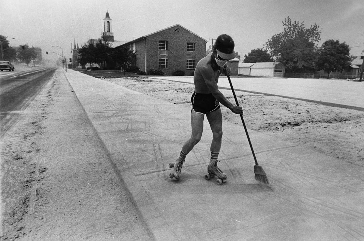 Chris Pederson cleans the sidewalk in Spokane, Washington in 1980. The entire area is covered in ash from the eruption of Mt. St Helens. Earthquakes and steam vent episodes occurred for 2 months after the eruption as well. One of the earthquakes caused the largest land slide in US history when almost half the volcanos side slid away. 57 people died during the eruption, with around $1 billion in damage caused. 1,600 times the energy released when the atomic bombs were dropped on Japan was released when Mt. St Helens blew. The ash covered the state, causing accident deaths due to poor visibility and also cost around $2-4 million per town to clean up.
