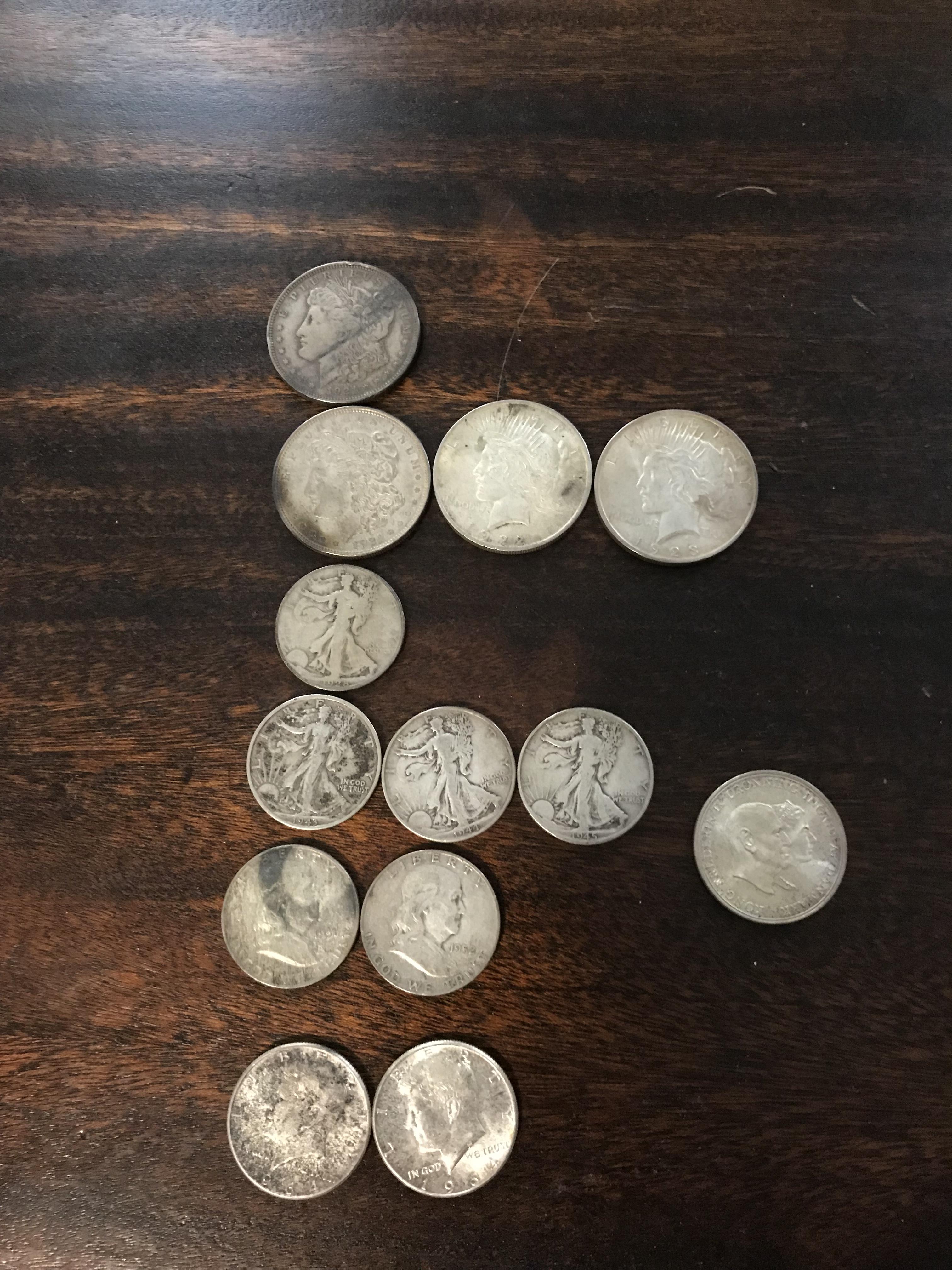 "Mostly just plain old coins but a few that stuck out. Some 1920s silver dollars in particular. 2 from 1921, a 1922 and a 1923. This has got to be worth something..."