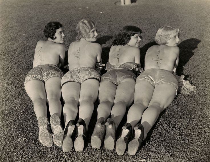 Bathing pinup girls pose somewhere in the US in 1926. Such pictures became more prevalent in the US around WWI, and would be heavily used through WWII.