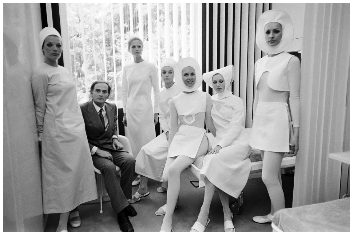 Fashion designer Pierre Cardin posing with Models in his "futuristic" vision of nursing uniforms in Paris, France in 1970.