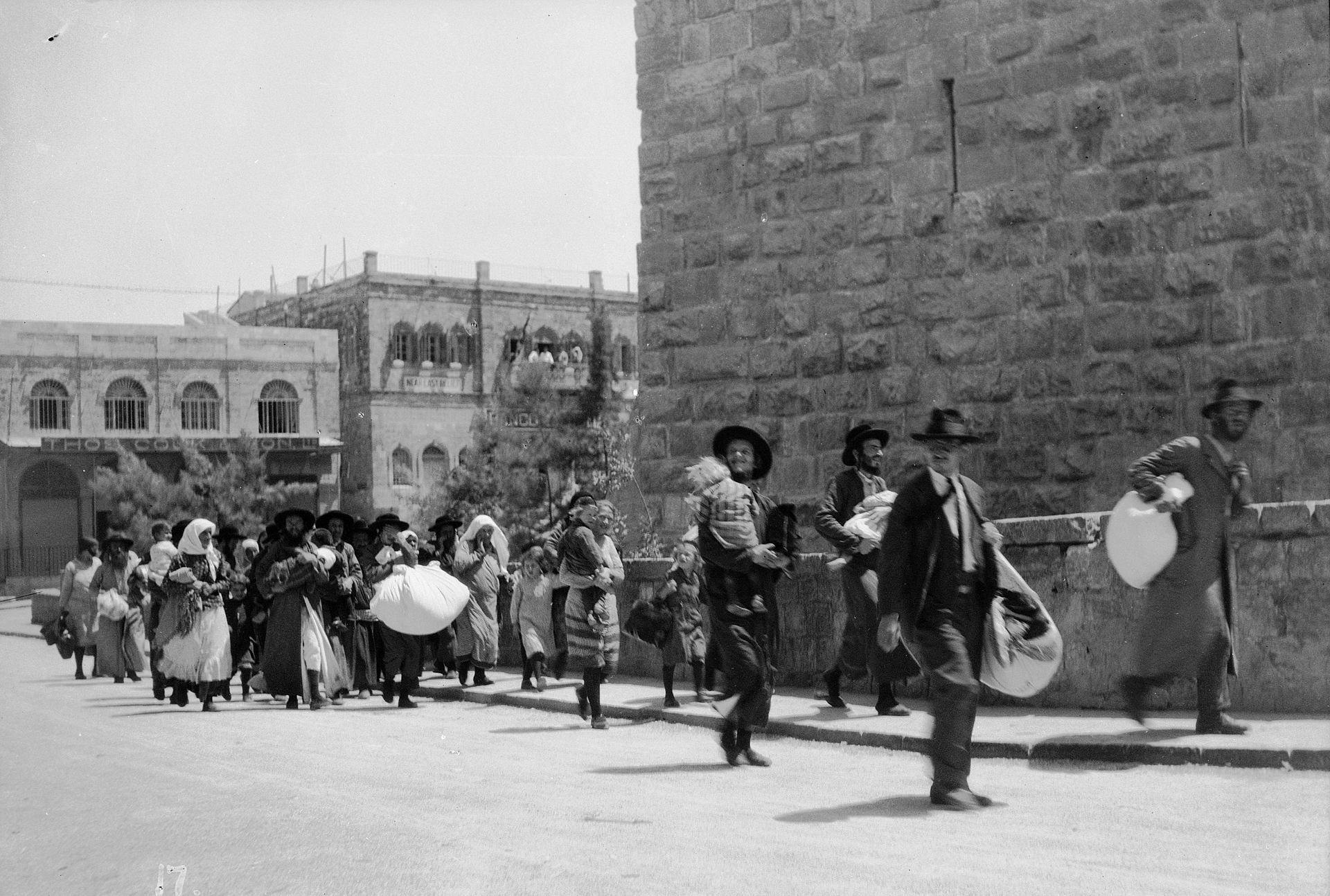 Jewish families fleeing the old city of Jerusalem during the Palestine Riots of 1929. This was when Britain had control of the area. The Muslims and the Jews had long standing conflicts over the sacred Western Wall, and demonstrations turned to violence. The Muslims simply attacked the Jews, and began to massacre them. 133 Jews were killed and another 339 others were injured in the attacks. Thousands fled the violence. The British troops moved in to quell the riots, and more violence occurred. In the fighting, the British killed around 110 Arabs and another 232 were injured.