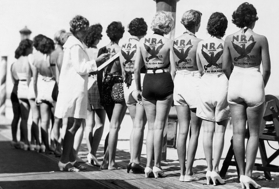 A beauty pageant in Miami, Florida, US in the 1930s. 6 of the participants have been paid to have large temporary tattoos promoting the NRA on their backs. This practice of advertising in incredibly old. Even Roman gladiators 2000 years ago would promote local shops before fights either verbally or with markings on their armor.