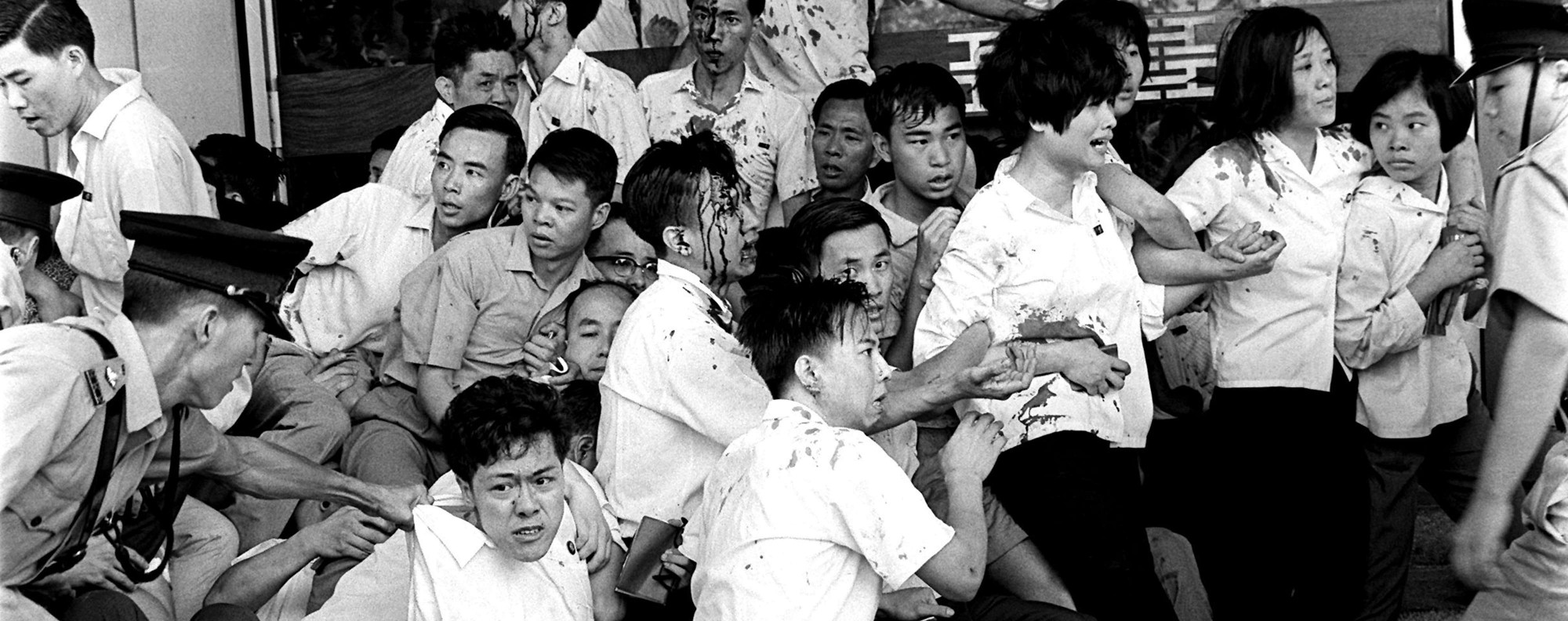 This picture shows bloody and beaten protesters being forcibly moved by riot police during the Hong Kong Riots in 1967. The riots were against the British Colonial rule, and were pro-communist, hoping to integrate with the rest of China. The police force, which were made up mostly of local Chinese, were sent in to disband the protestors when instead it turned violent. In the hard crackdown that followed, 52 people were killed, with another 800 wounded. The police also arrested some 2000 people including all suspected leaders of the protests. To combat this, small terrorist actions such as bombing occurred against the police and British Colonial rule. Eventually, all order was restored and Britain retained full control of Hong Kong.