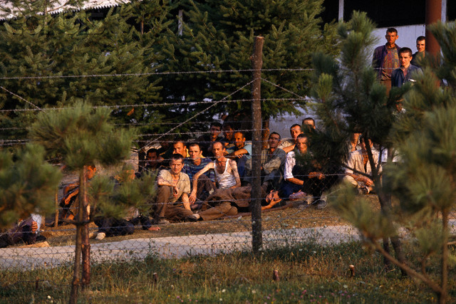 This is a picture of Bosniaks (Muslim Bosnians) at the Omarska concentration camp run by the Serbians during the Bosnian War in Bosnia in 1992. It was basically a concentration camp being disguised as a prisoner camp. The Bosnian War had ugly and brutal acts against ethnic groups. Official death toll from such acts was only 10,000 or so, but many believe the number killed was higher.