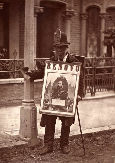 A boardman photographed in London, England in 1877. This was part of a series called "Street Life in London" by photographer John Thomson. Men such as these were often quite poor, and sometimes were even trampled by carriages on busy streets as they were forced by police to stay off the sidewalk.