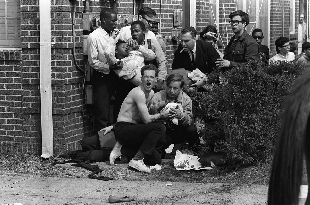 A man asks for help after some protestors marching for Civil Rights were beaten in Birmingham, Alabama, US in 1965. Despite often marching very peacefully, pro segregation local police or fellow students and civilians would attack anyone association with desegregation movements. Local Southern Whites as well as Whites from the North would join together and march all over the South with blacks to show unity in pushing for desegregation. Sadly, the ugly racism of America often put many protestors in the hospital, or worse, the morgue. The movement would prevail, and eventually the federal government forced all places in the US to not be legally allowed to discriminate against race.