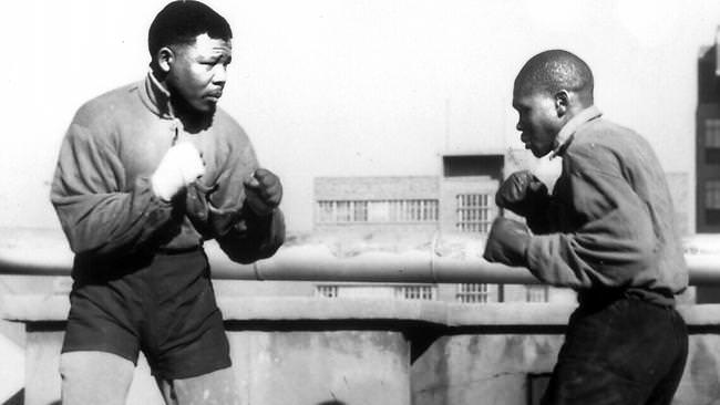 Nelson Mandela (left) sparring with professional boxer Jerry Moloi on the rooftop of the South African Associated Newspapers building in downtown Joburg, 1953.