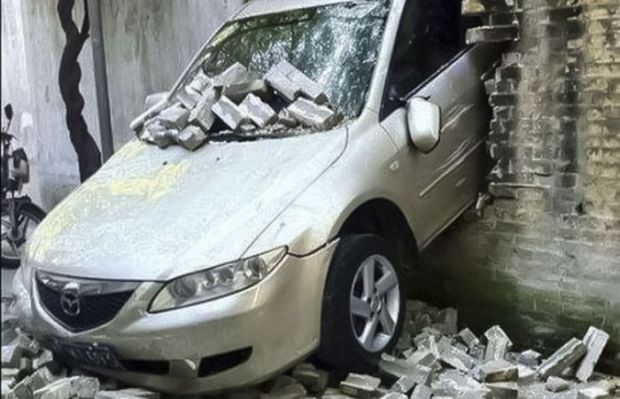 car through wall -