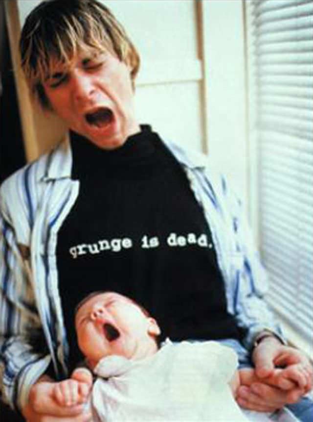 Kurt Cobain goofing off with his daughter in 1993. He appeared very close to his daughter, but had personal battles that consumed him. Sadly, he would commit suicide after escaping a rehab facility the following year.