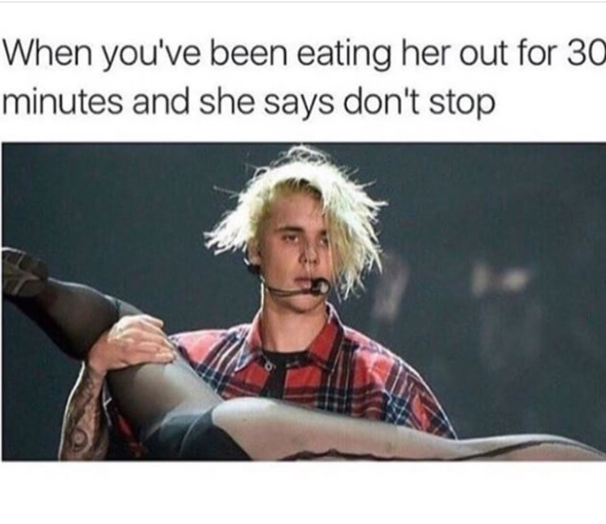 Dirty meme of Justin Bieber holding one of his dancers upside down and caption joking how it feels after 30 minutes of eating her out and she says don't stop, with his hair all over the place
