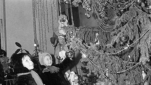 Russian children decorate a Christmas tree in 1935.