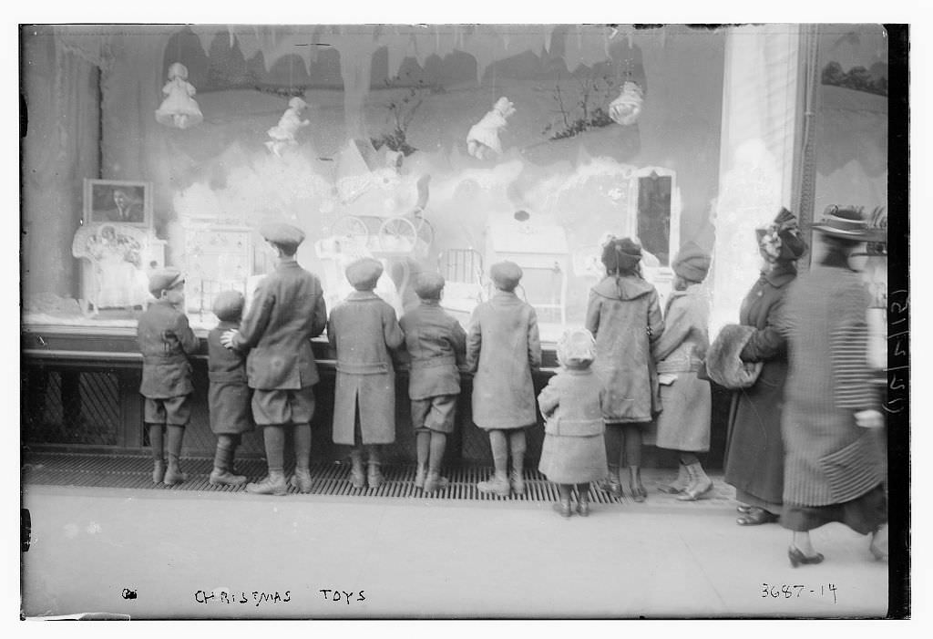Children looking at the new Christmas toys on display in a shop in NYC, US in 1920.