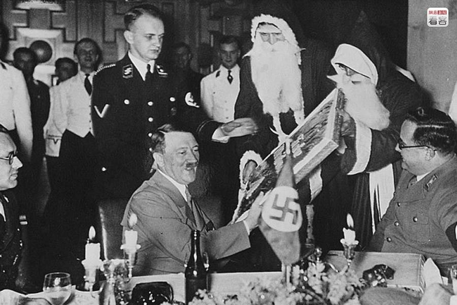 German chancellor Adolf Hitler receiving gifts from Santa in Berlin, Germany in 1937.
