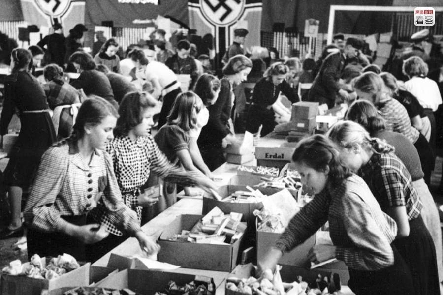 Nazi women in Berlin packaging Christmas gifts to send to their troops in 1942.