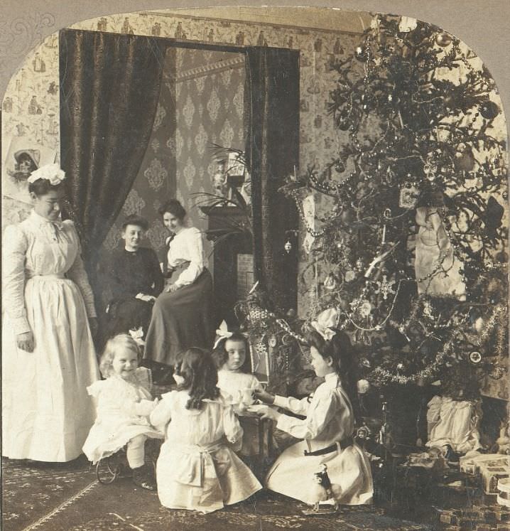 A family in London, England watch the children open their Christmas gifts in 1908. The women on the left appears to be the nanny.