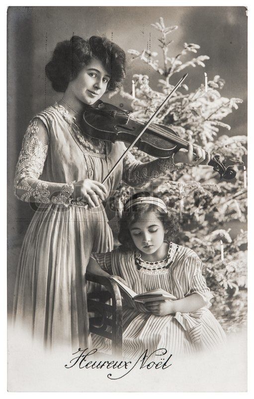A mother poses with her daughter for a Christmas card in France in 1910.