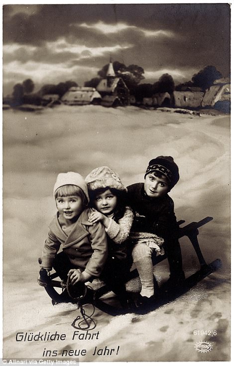 Children ride a sled for a Christmas card in Germany in 1913.