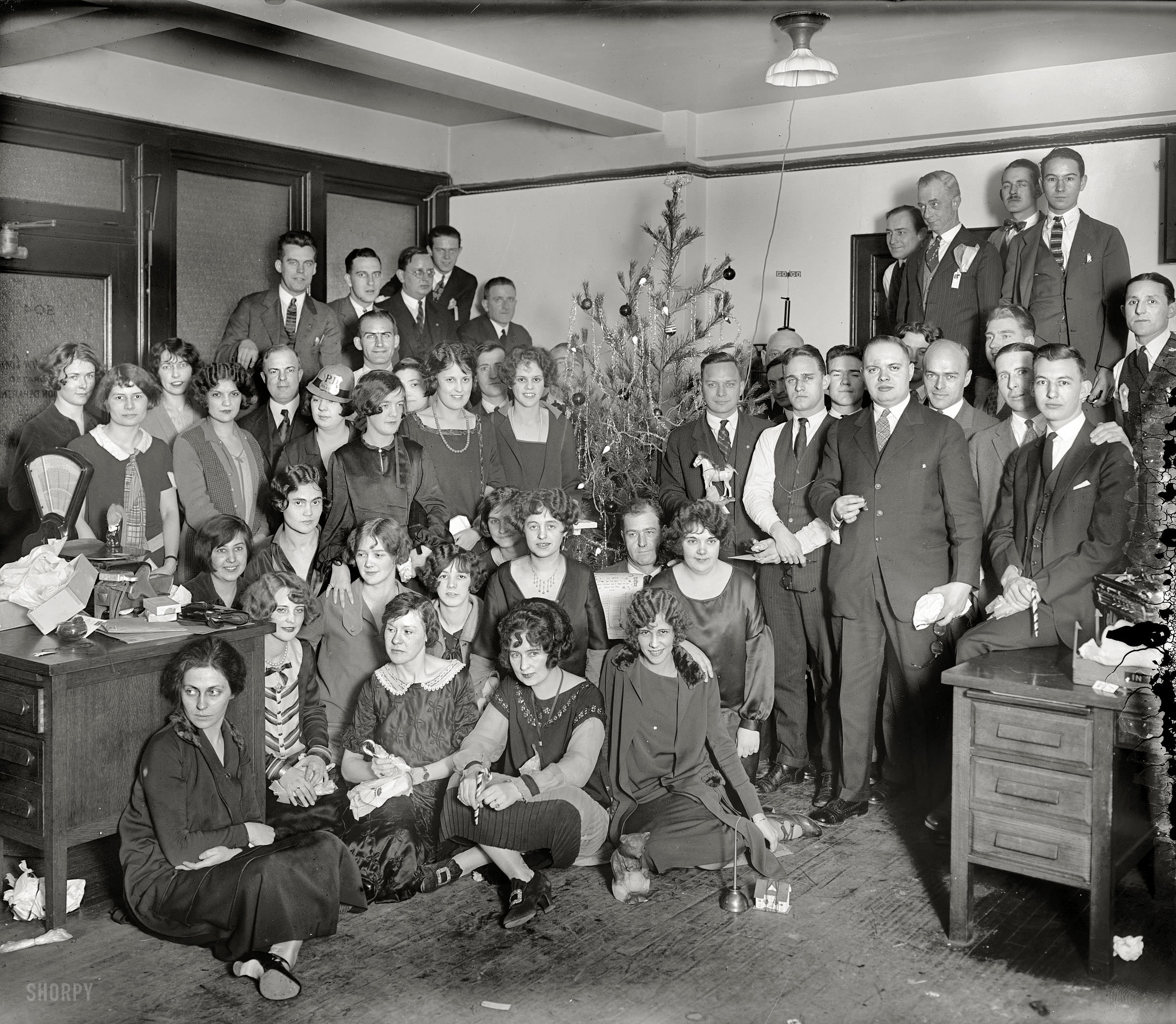 People pose for an office Christmas party in 1919.