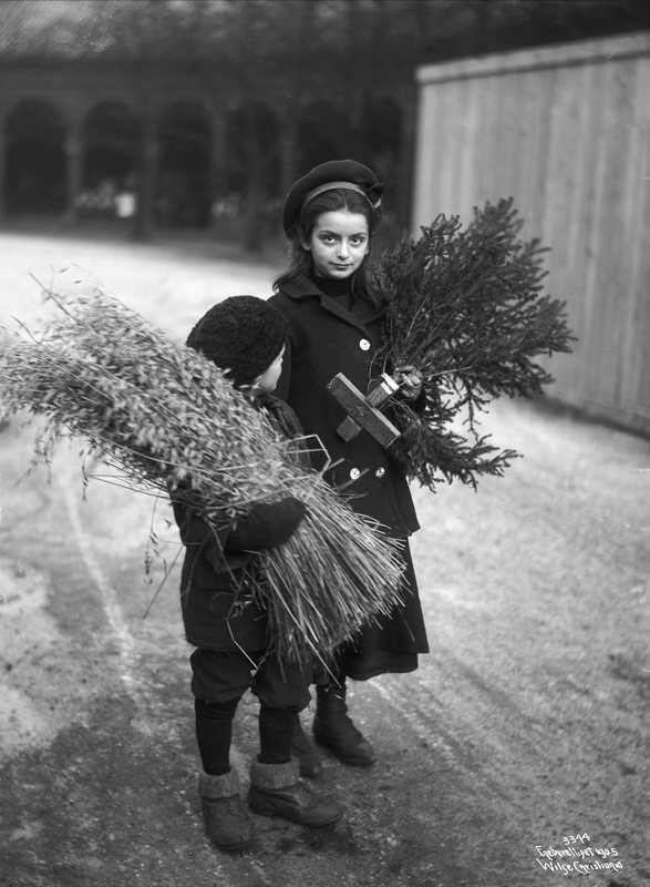 Two children pick out decorations for Christmas in Oslo, Norway in 1927.