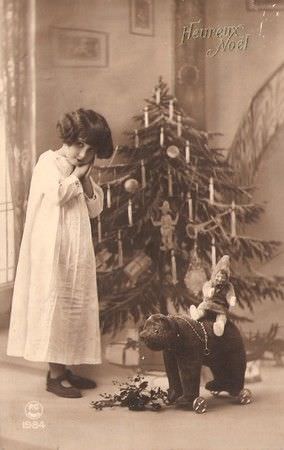 A girl poses with her Christmas toys in France in 1920.