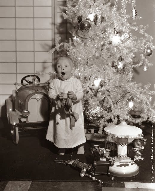 Child actor baby Leroy reacting to receiving Christmas gifts in 1933.