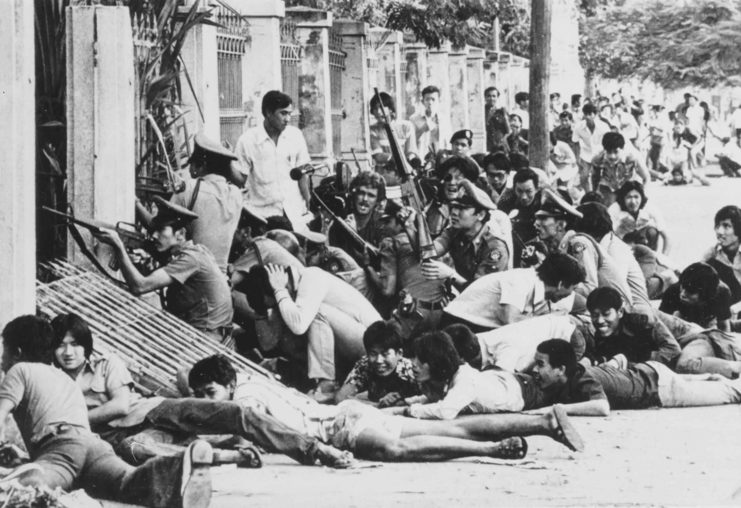 An angry mob accompany soldiers as they prepare to storm a school during the Thammasat University massacre in Bangkok, Thailand in 1976. The students had been protesting the return of exiled military dictator Thanom Kittikachorn, and even put on a play mocking him. The army and Kittikachorn supporters then surrounded the school, trapping 6,000 students. They then stormed the school, and killed up to 100 students, wounding another 200, if not more. They then hung some of the bodies, and used them as human pinatas (see part 10). Interesting enough, as you can see, there are at least 3 members of a news crew in this picture. The army and mob did not stop them from reporting the events, which is why we have such images documenting such a massacre.