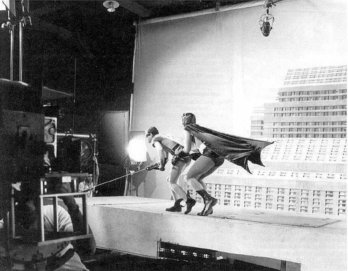 This photo depicts Adam West and Burt Ward in 1966 filming for Batman, in a scene where they are scaling a building in Gotham