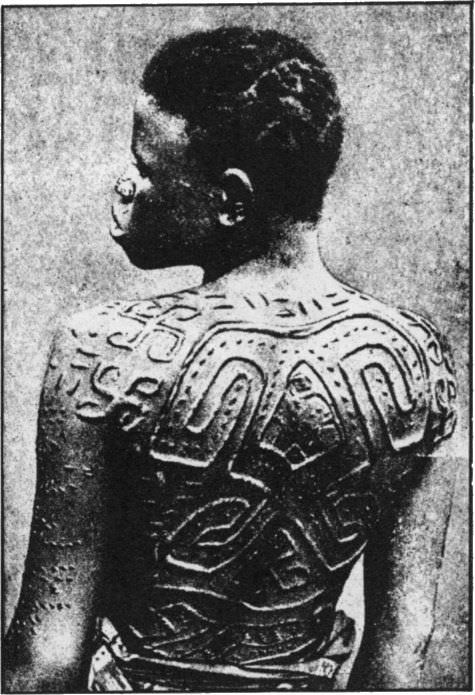 A tribal women shows off the scarification done to her in Belgian Congo in 1935. On both of her shoulders are the symbol of luck- Swastika, the Swastika has been used for thousands of years by many different cultures around the world way before the Germans ruined the meaning of the symbol. As for scarification, it is a way to beautify a person, and was often done in African Tribes of the Congo, Sudan, and surrounding areas. It was done both for men and women, and all over their bodies and faces. This practice still exists, but is not nearly as common.