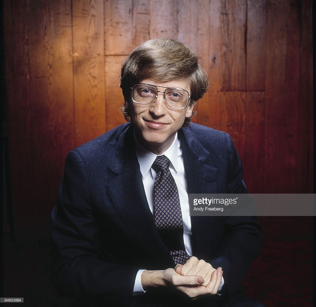 Portrait of a young Bill Gates, co-founder of the software company Microsoft, smiling as he leans forward towards the camera, New York City, 1984.