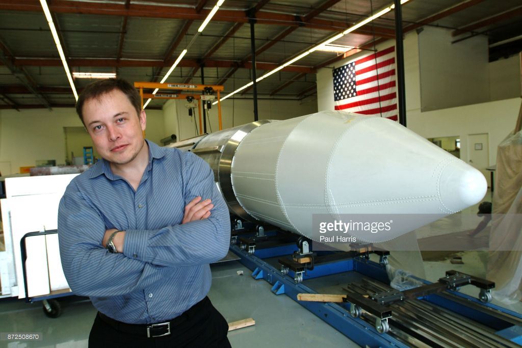 Elon Musk, multi millionaire, rocket scientist, Tesla and Space X founder and the man who inspired Tony Stark's character in Jon Favreau's 'Iron Man' stands beside a rocket March 19, 2004 in El Segundo, Los Angeles, California.