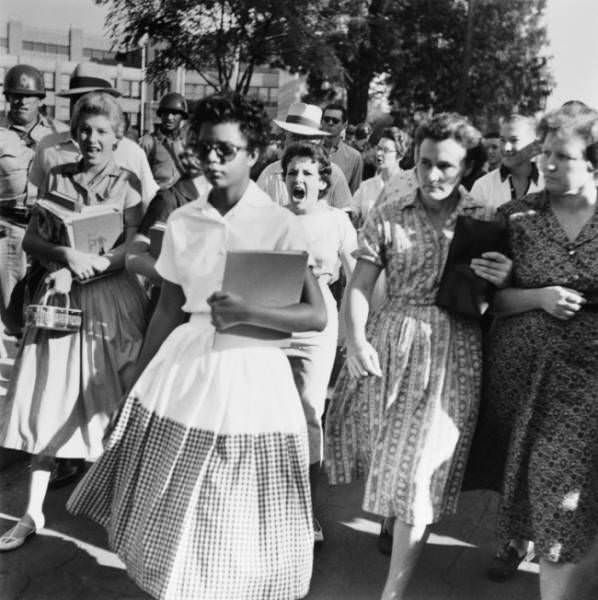 Elizabeth Eckford was one of a group of African-American students who were the first black students ever to attend classes. This photo was taken in 1957, right after the Supreme Court of the United States decided it was illegal to segregate children in schools.