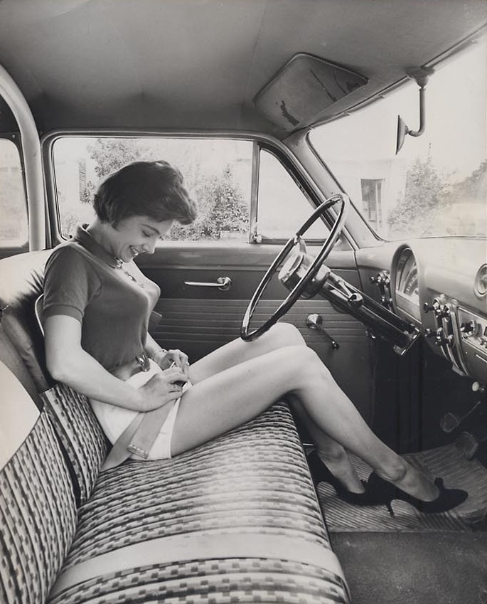 Model showing how to use a seat belt in 1958.
