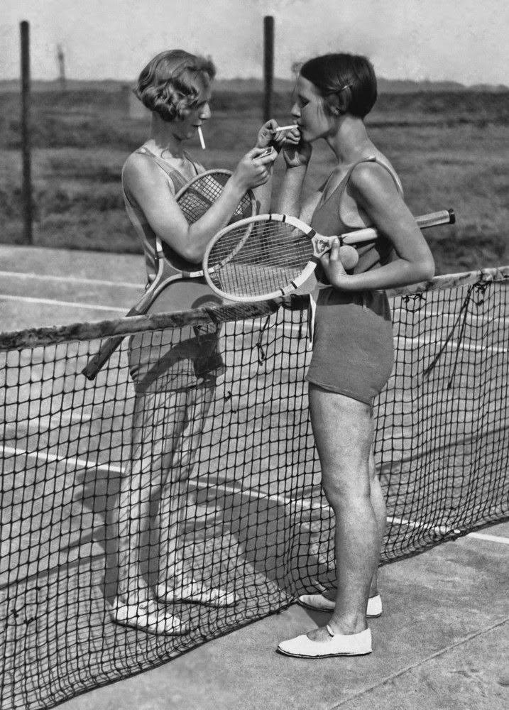 Smoke break during a tennis game in 1938.