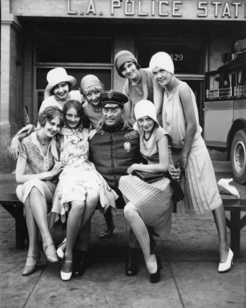 A cop with a bunch of models in L.A., 1923.
