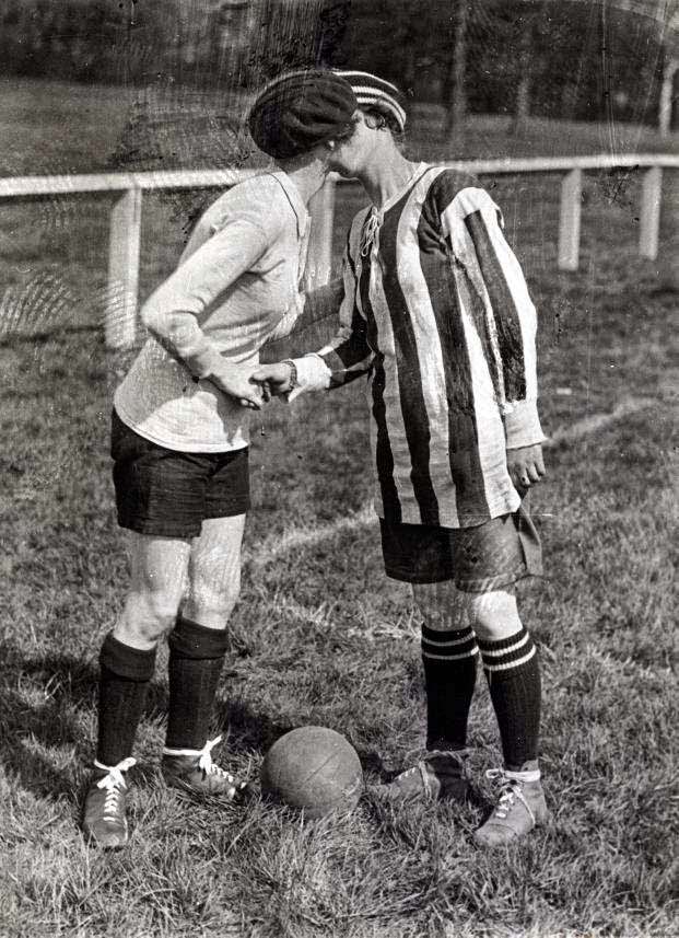 British and a French football (soccer) players share a kiss on the cheek before a match in France in 1920.