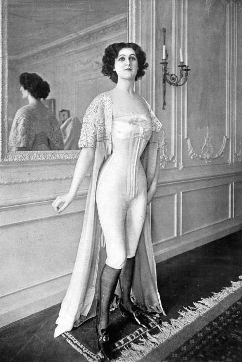 A woman models long john undergarments for women, Paris, France in 1901.