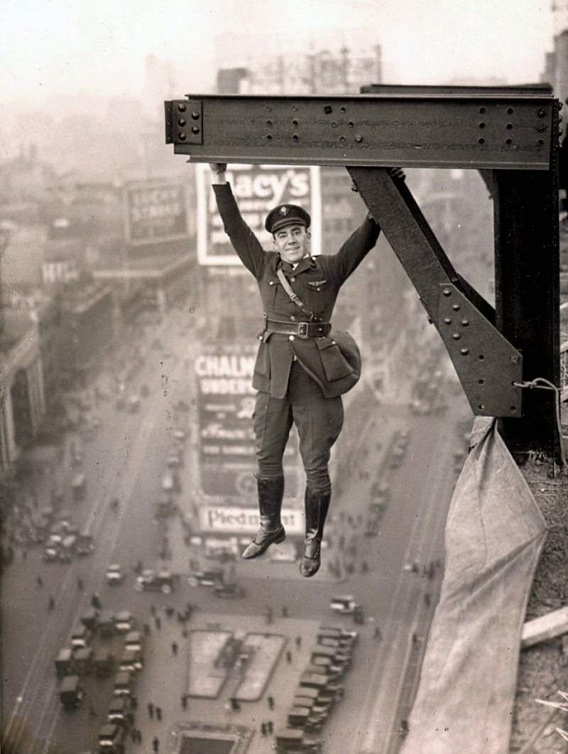 A police officer in NYC, US hangs off a building for a stunt.