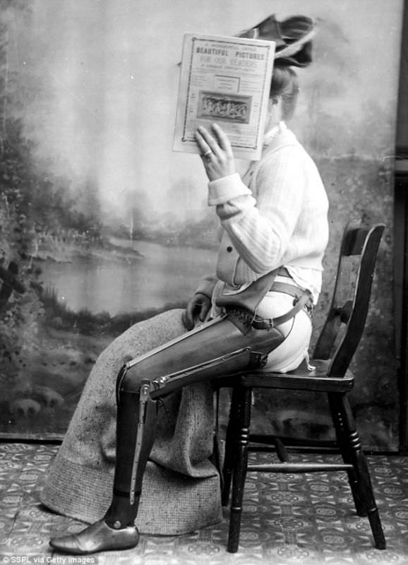 A woman hides her face but shows off her prosthetic leg somewhere in the US, 1890.