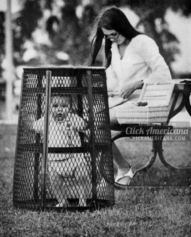 A mom uses a trash can to contain her baby while she crochets in the park somewhere in the US, 1969.