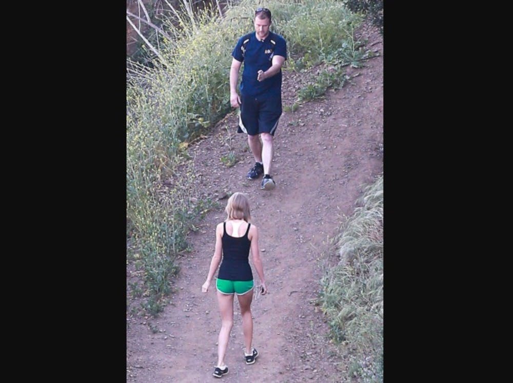 Taylor Swift walks backwards so that reporters get photos of her back.