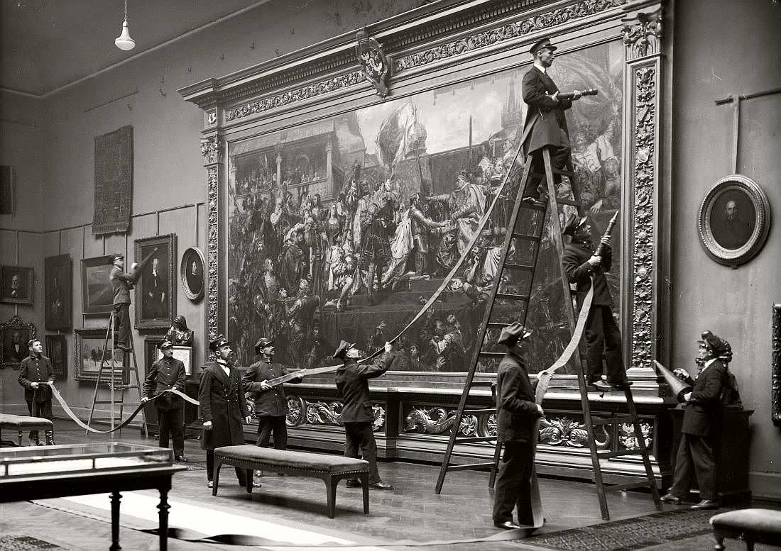 Museum employees prepare to clean around a painting in Warsaw, Poland in 1930.