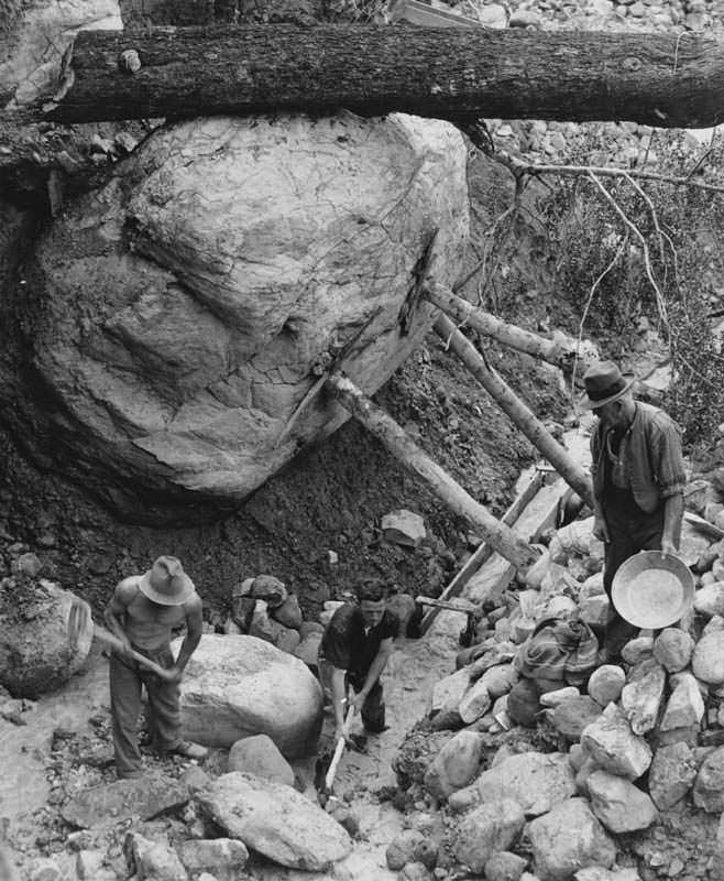 Workers dig to create a constant stream to search for precious metals in New Zealand in 1947.
