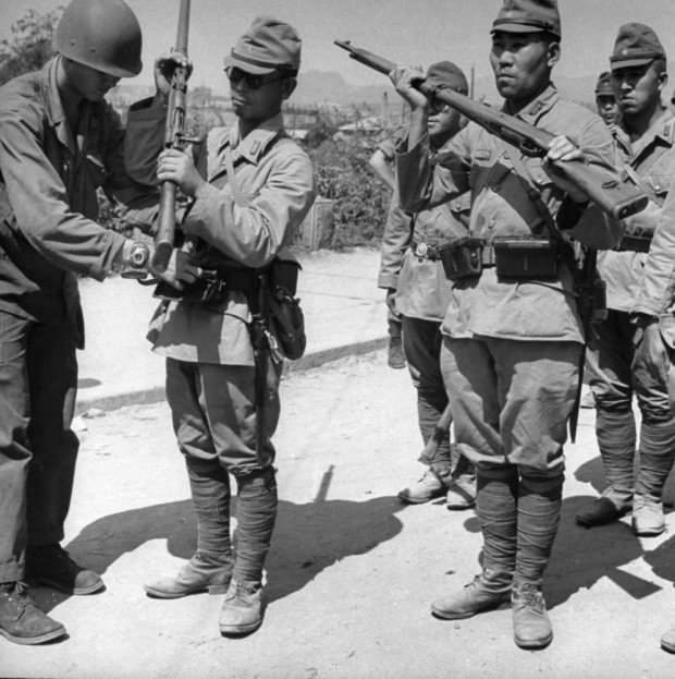 Japanese soldiers being disarmed in Korea, 1945.