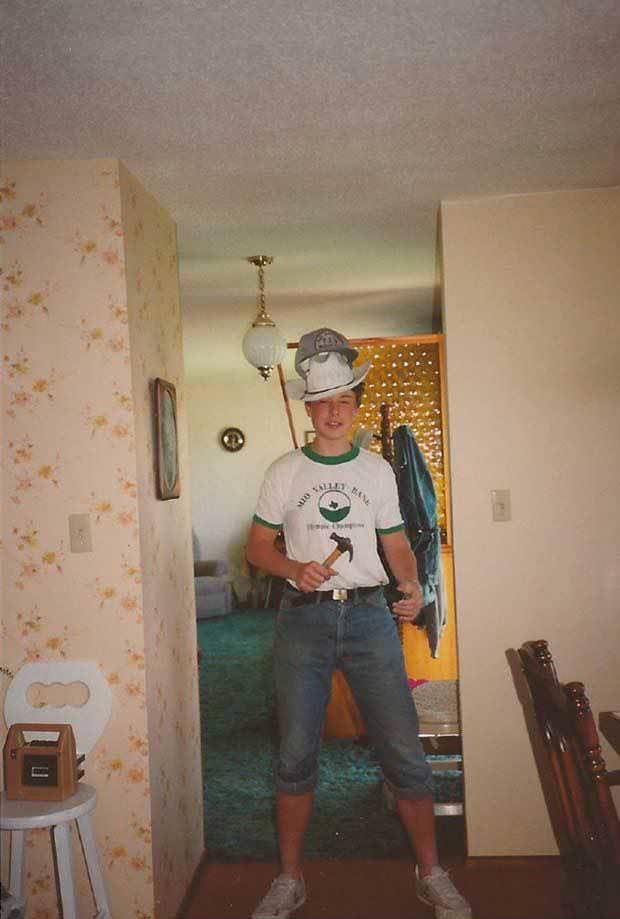 A 17 year-old Elon Musk, wearing two hats and holding a hammer the wrong way. Clearly his genius started early ;p