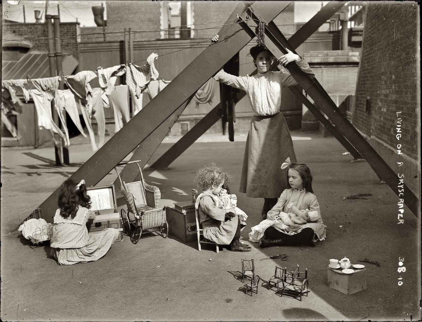 Children play while their mom poses in NYC, US in 1892.