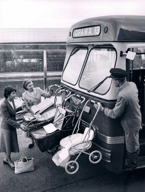 Putting baby carriages on the front of a bus in New Zealand, 1955.