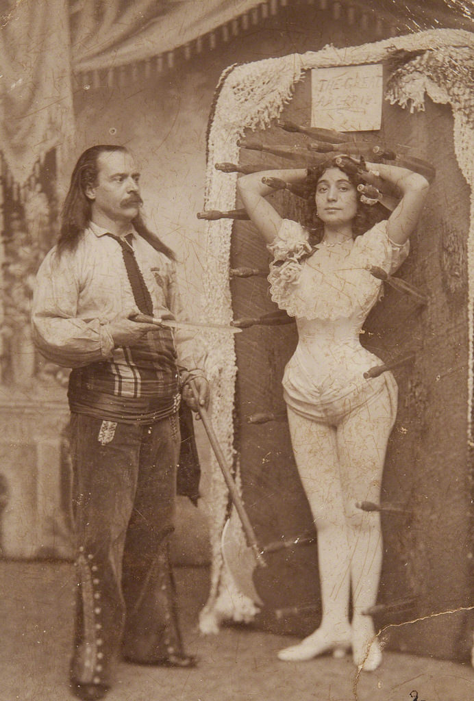 Knife thrower Signor Arcaris with his sister Miss Rose Arcaris as part of PT Barnums circus in the US, 1900.